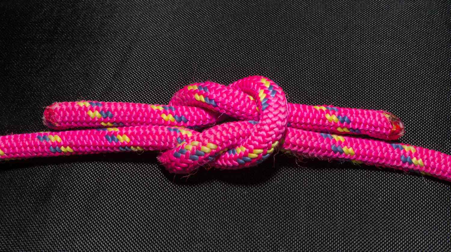square knot accessory on table | How To Tie A Square Knot | Step-By-Step Instructions | square knot | basic knots | Featured
