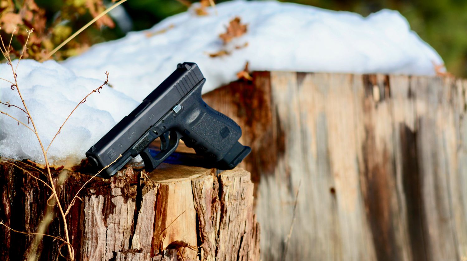 Glock 19 product shot outdoor autumn snow | Glock 19 For Concealed Carry Review | Featured