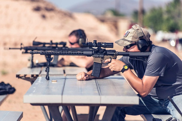 man firing black rifle on desert rifle shooting tips ss