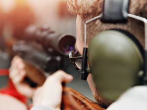 Featured | Man directs firearm gun pistol at target firing range or shooting range | Steps For Better Rifle Marksmanship