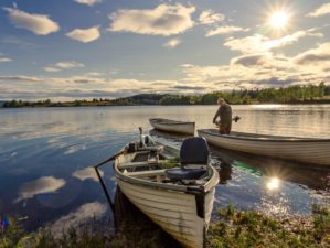Featured | Man riding on a small boat | Wacky Fishing Tips To Help You Fish Like A Redneck
