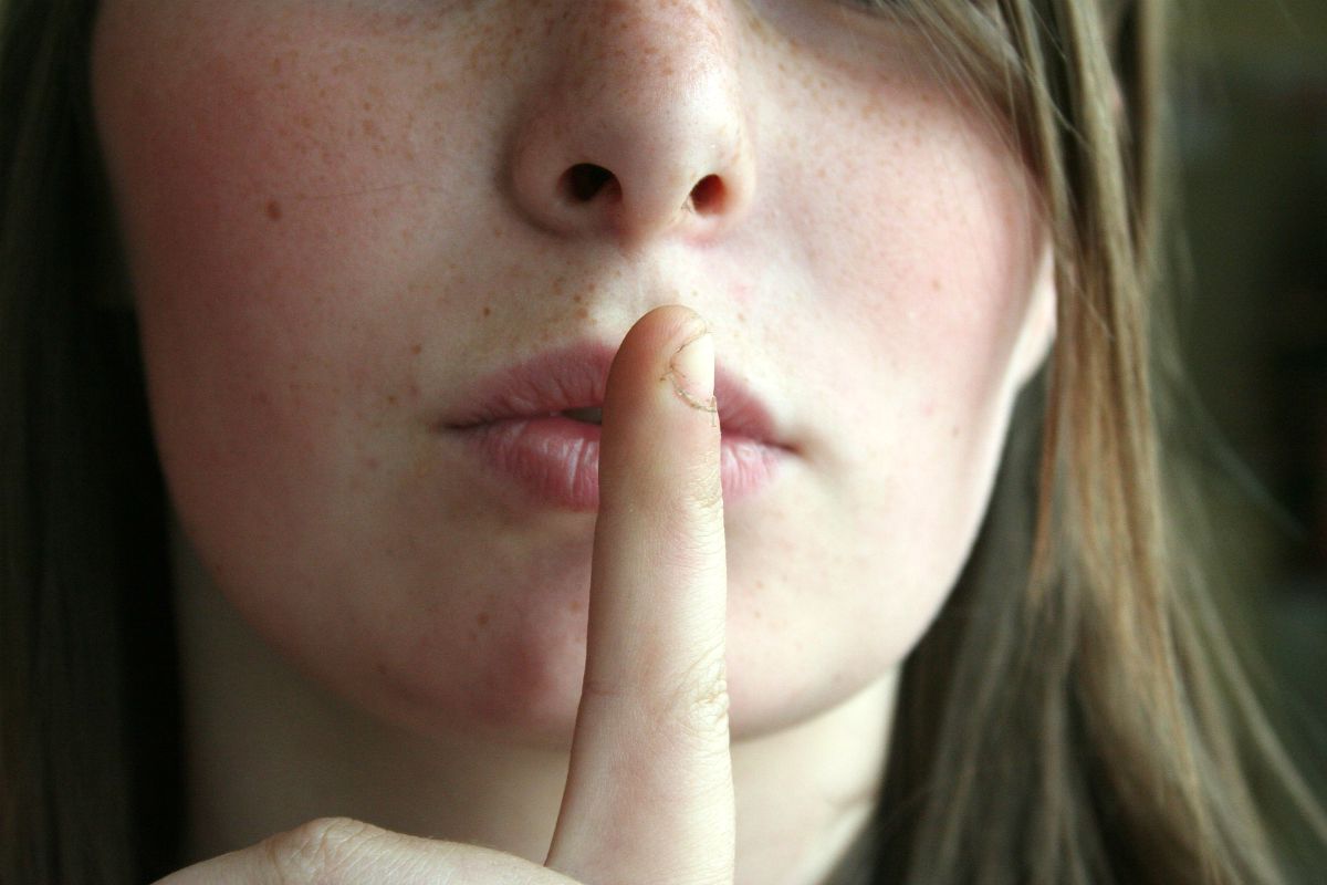 Woman finger on lips a sign of silence | How To Argue With Non-Preppers 