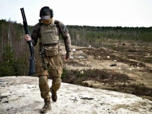 Young militarist man in army uniform with tactical vest | The Tactical Shotgun Scabbard By Beez Combat Systems | Featured