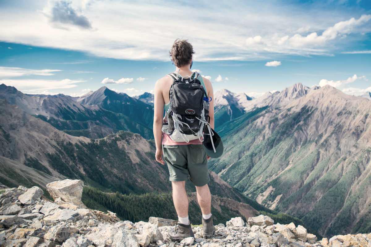 man wearing backpack on top of the mountain | Prepper Supply Items You Can Buy At Costco | prepper supply items | prepper gear list