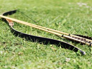 Featured | Black and brown bow on grass field during daytime | How To Build A DIY Longbow [Video]