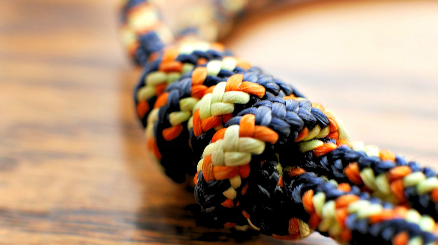 Featured | Braided nylon rope on wood grain | Best Knots For Camping And Survival