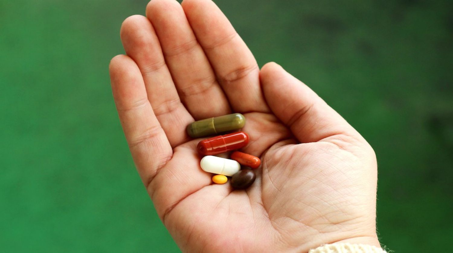 Featured | A person hand holding capsule in hand | Best Vitamins For Men & Women And OTC Medicines To Stock Up On