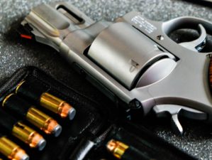 Featured | Metal revolver .44 magnum pistol gun with jacket soft point(JSP) bullet on dark background | The Ultimate Concealed Weapon | Smith And Wesson Model 642