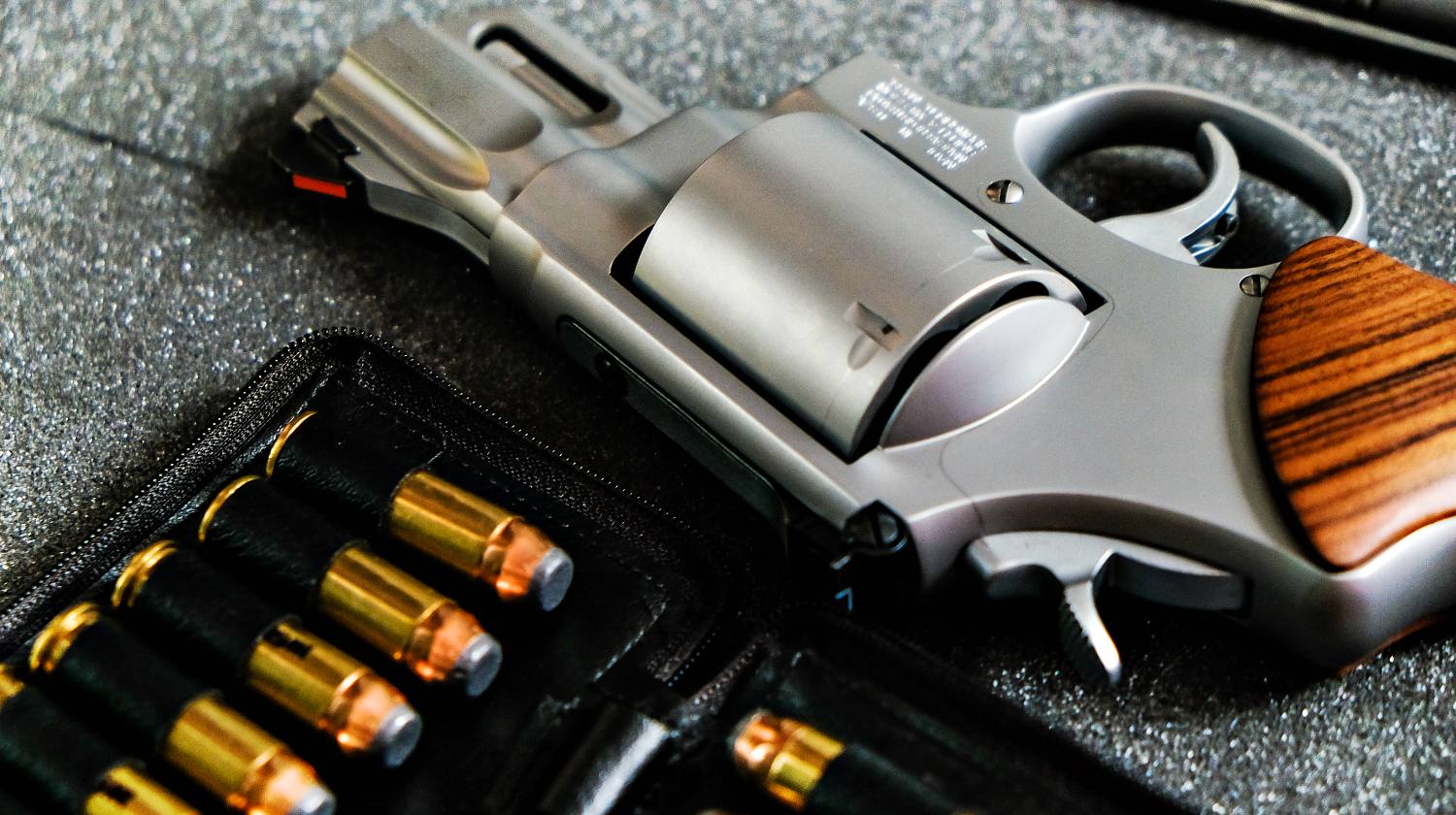 Featured | Metal revolver .44 magnum pistol gun with jacket soft point(JSP) bullet on dark background | The Ultimate Concealed Weapon | Smith And Wesson Model 642