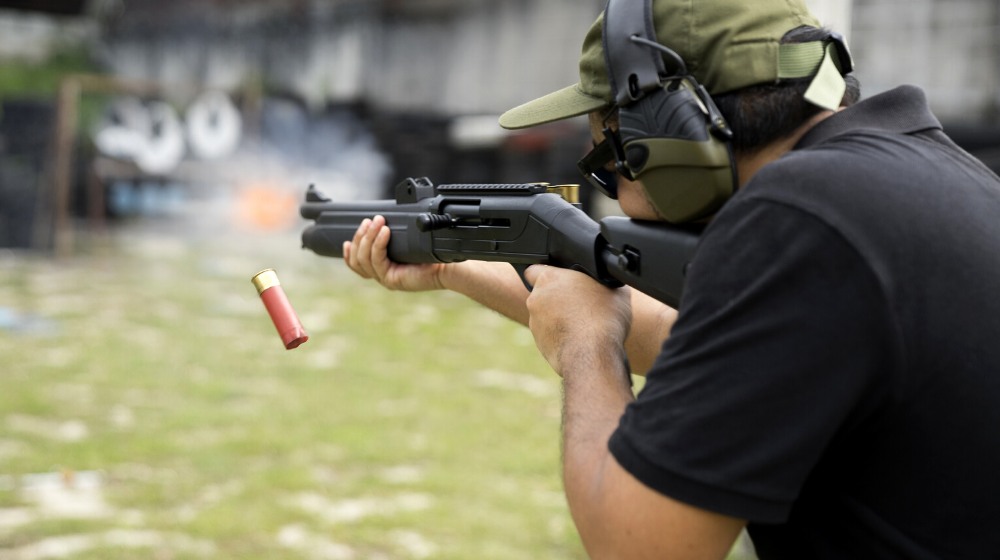 man shooting on outdoor range selective | Benelli M3 Convertible | Gun Carrier Shotgun Reviews | featured