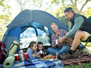 Feature | Family having snacks and coffee outside the tent at campsite | Camping Snacks | Appetizing Recipes Perfect Outdoors