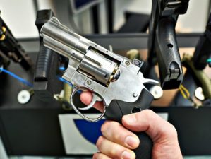 Featured | Revolver dan wesson in the hand of the buyer in the arms store | What To Look For When Buying New Guns For First Time Users