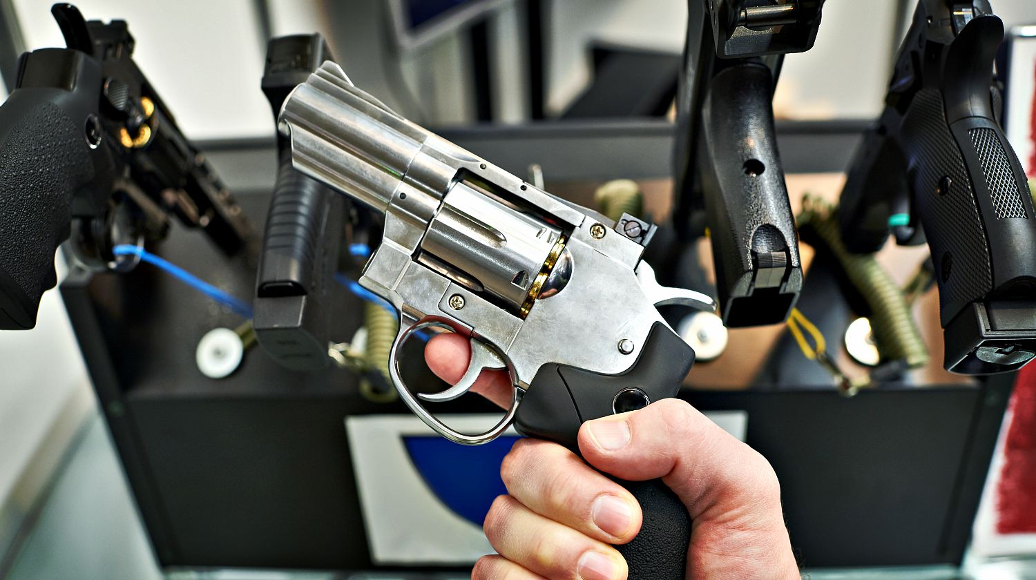 Featured | Revolver dan wesson in the hand of the buyer in the arms store | What To Look For When Buying New Guns For First Time Users