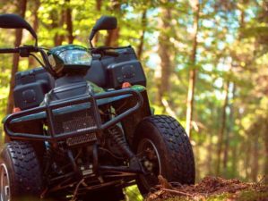 ATVs parked in the parking lot in the forest doomsday defense feature getty
