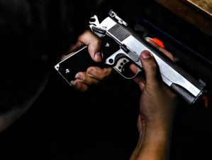 Gun in the hands of a man | Why It's A Bad Idea To Put A Gun In The Trash | Featured