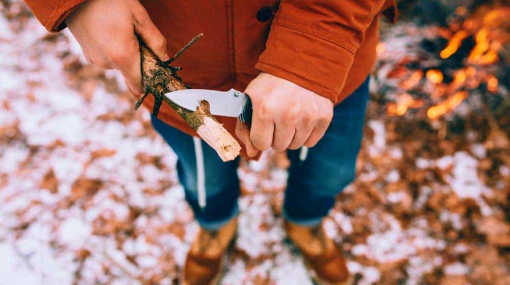 man uses knife whittle stick out pocket knives feature ss