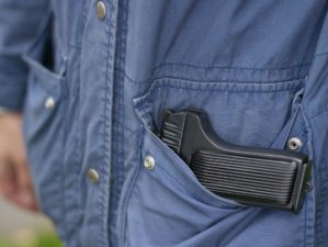 Feature | A man legally carries a firearm in his pocket for protection | The 5 Best Pocket Sized Pistols Available