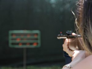 Feature | Back view of a woman practice shooting | Best Home Defense Guns | When The Cops Are Minutes Away