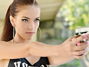 Feature | Beautiful woman with gun | What's The Best Handgun For Women?