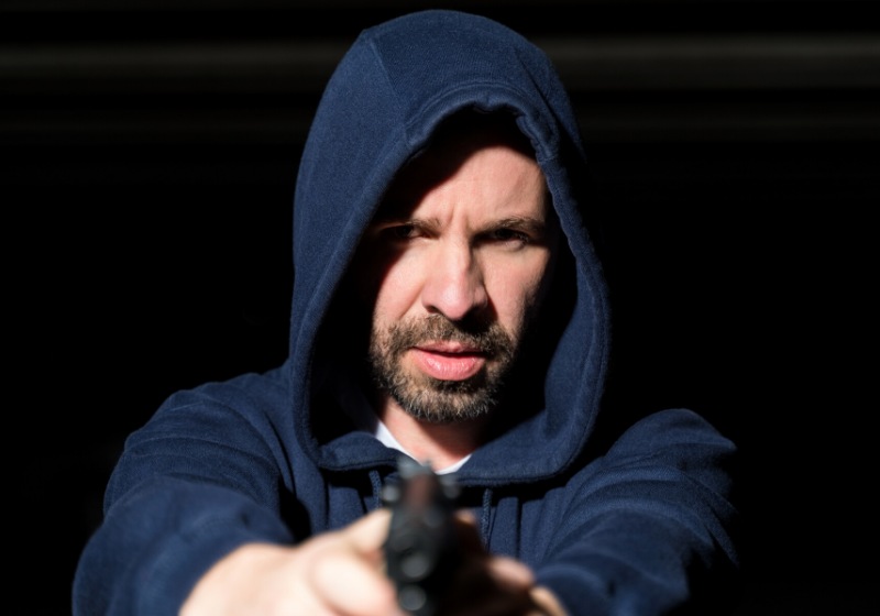 criminal wearing hoodie while holding gun | gun to the head