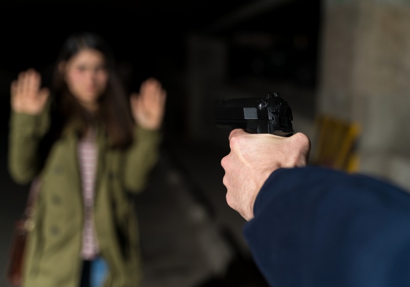 cropped hand criminal pointing gun female | gun pointed to head