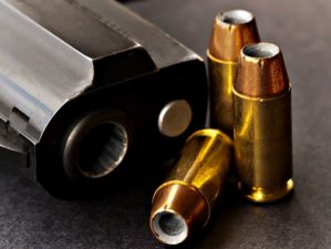 Feature | Bullets next to black handgun | Modern Self Defense: .357 Sig