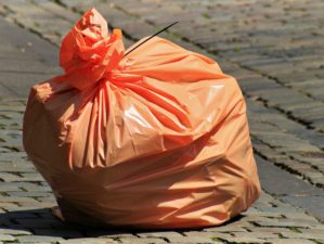 Feature | Orange garbage bag in the street | Uses For Trash Bags | Bug Out Bag Essentials
