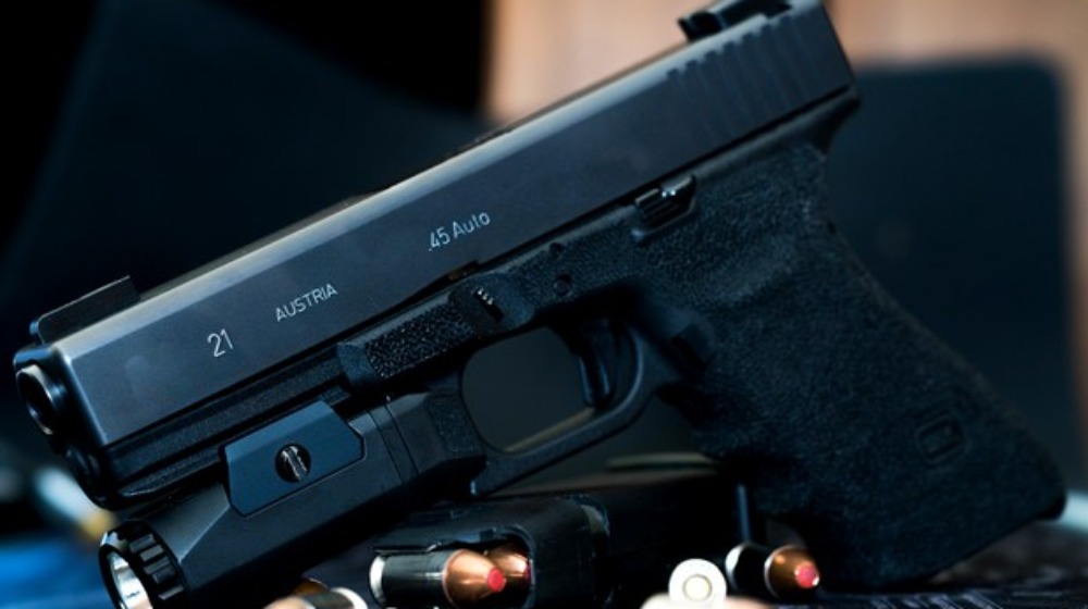 Glock 21 handgun with flash light and hollow point bullets home defense handgun ss feat