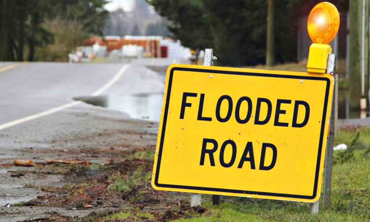 Yellow sign that the road is flooded | Flood Survival Tips | How To Survive Before, During, And After A Flood 
