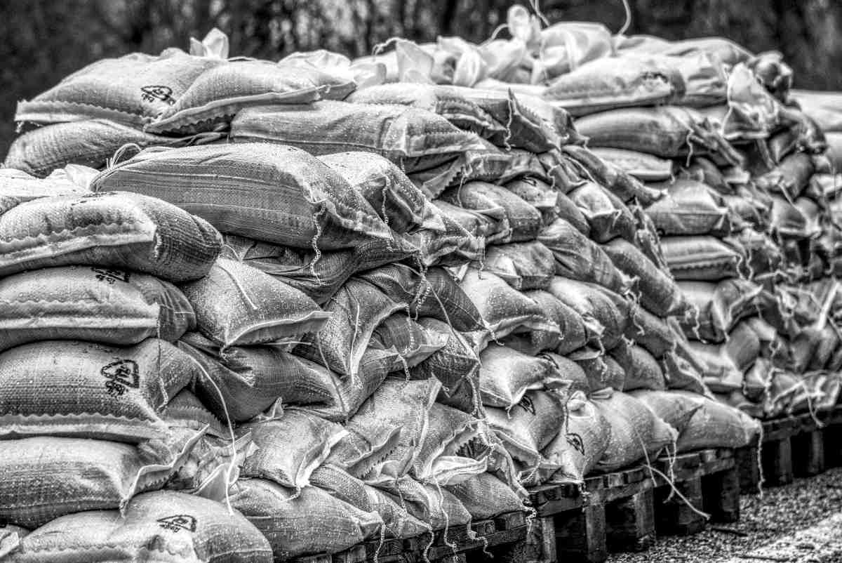 Pile of sandbags black and white background | Flood Survival Tips | How To Survive Before, During, And After A Flood 