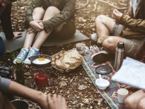 group of people sitting on the ground while cooking egg | DIY Survival Food You’ll Actually Want To Eat | survival food | survival food and gear | Featured