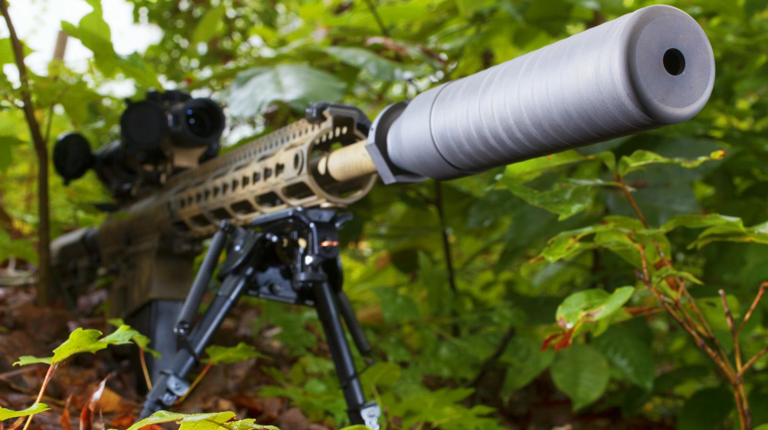 Feature | Semi automatic rifle with a suppressor in the trees | How Do Suppressors Work?