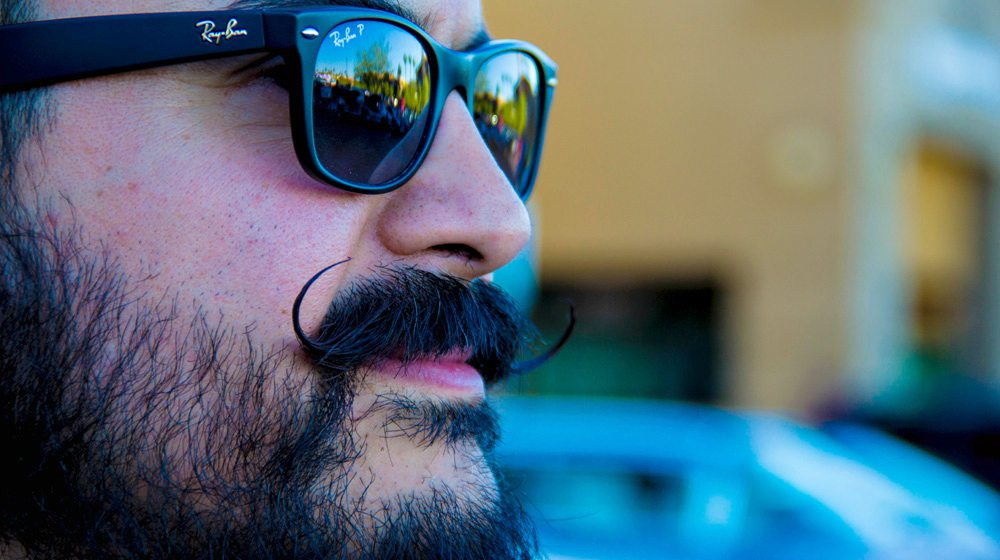 Feature | man in shades with a mustache | How To Trim A Mustache In Easy Steps