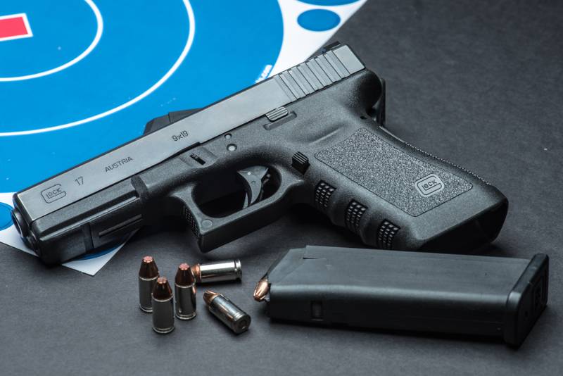 Closeup of Glock 17 semiautomatic handgun and 9mm amunition and magazine 9mm Handguns For Women
