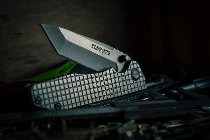 selective focus photography of black pocket knife | Maine Knife Laws