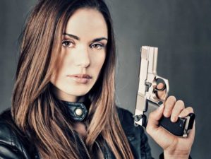 Feature | Woman with handgun | Best Guns for Women Living Alone