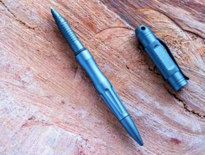 Feature | Tactical pen and flashlight placed on wood | Tactical Pen Roundup: The 7 Best Tactical Pens For Your Dollar