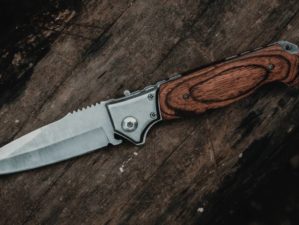 brown handle silver knife on brown wooden | Knife Laws In The United States | What Blades Are Legal In Your State? | Featured