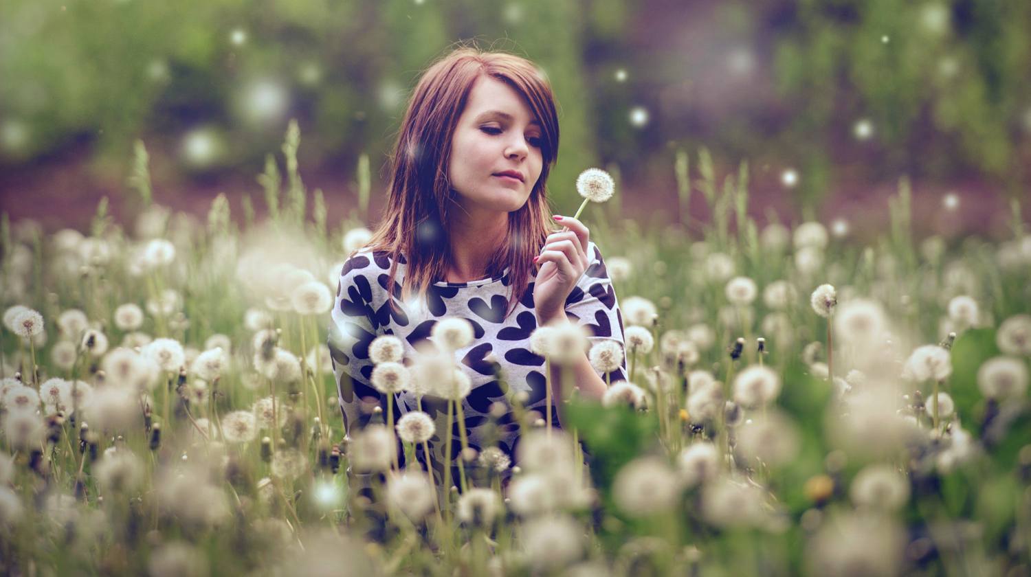 Feature | Woman in dandelions garden | Benefits of Dandelions | More Reason To Love The Survival "Weed"