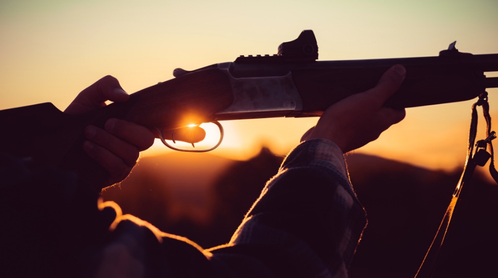 rifle hunter silhouetted beautiful sunset powerful | Finding Your Norinco SKS Production Date | featured