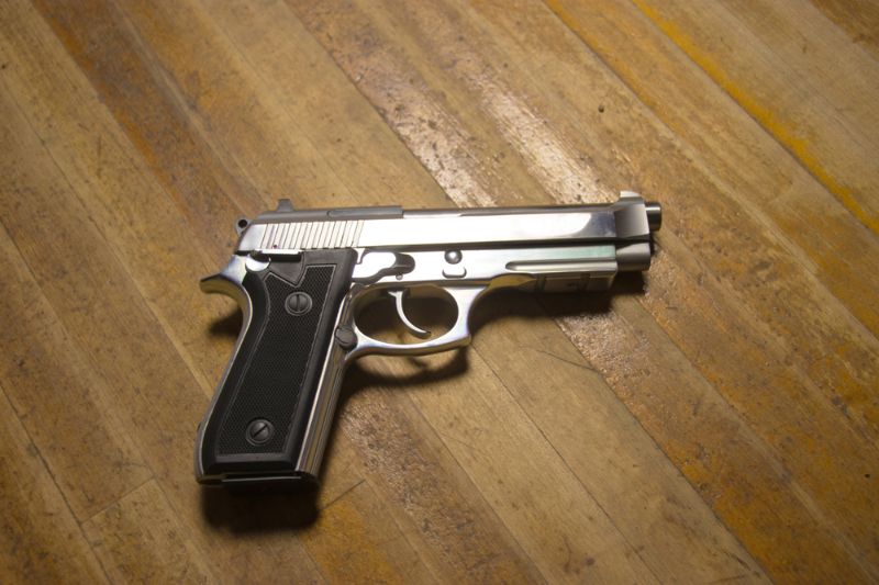 Semi Automatic pistol on wood background Taurus Firearms Recall