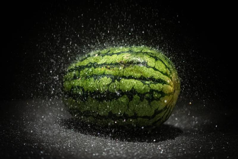 Watermelon taking a shower on a dark background with droplets splashing | how to make bullets
