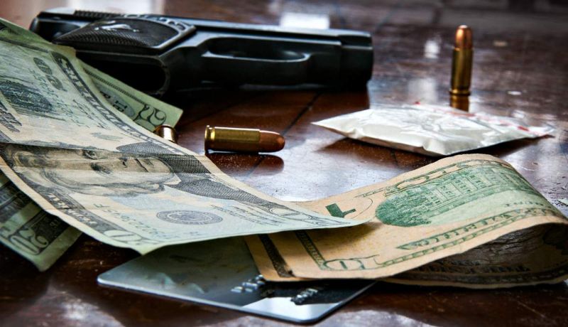 A gun with bullet and US dollar banknotes | What's The Best Handgun For Beginners?