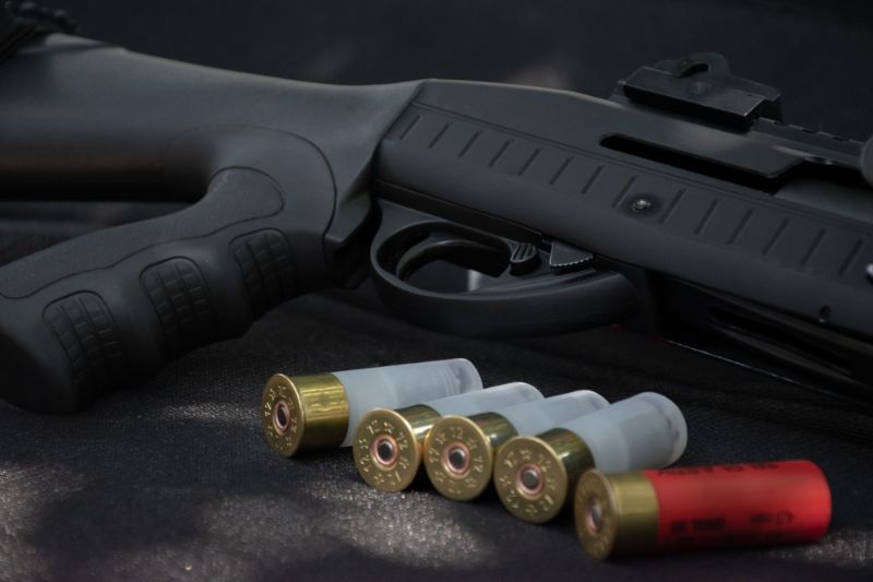 shotgun-cartridges-on-black-leather-background home defense pump shotgun