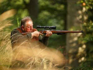 Man hunting using his rifle | .450 Bushmaster – Review and Recommendations