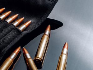 rifle bullets cartridges on black shiny | 350 Legend – Review and Recommendations | featured