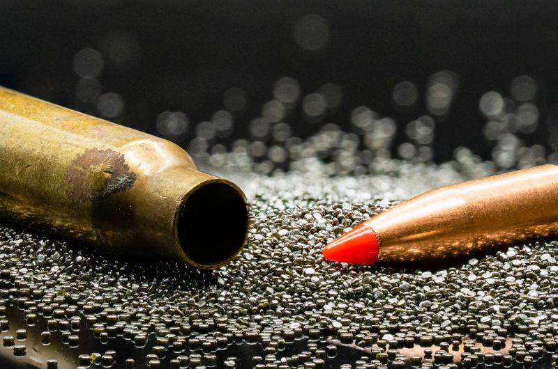 Macro shot of bullet, brass casing and gun powder | best muzzleloader