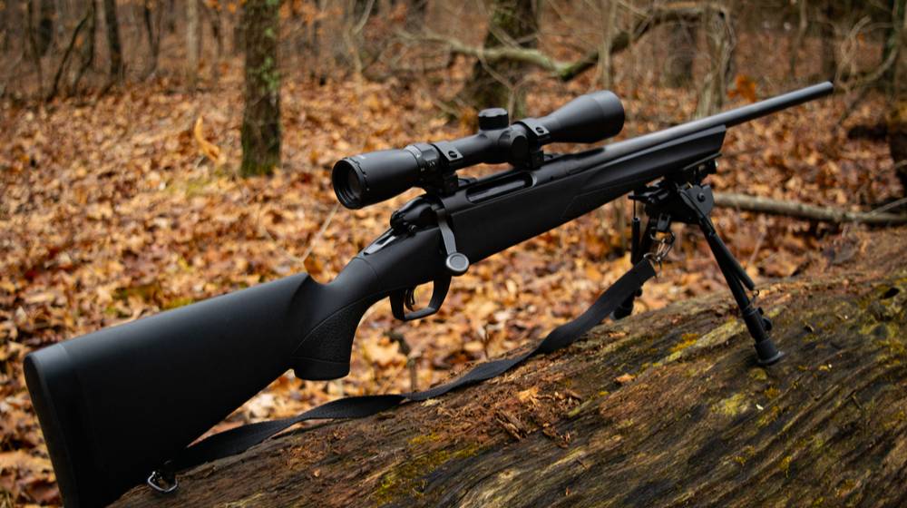 bolt-action-rifle-on-log | 7 Best Scope For An AR-15 For Coyote Hunting | Featured