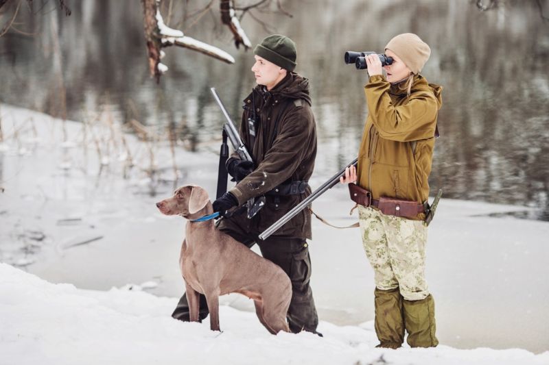 two-hunters-rifles-snowy-winter-forest | places to coyote hunt near colorado springs