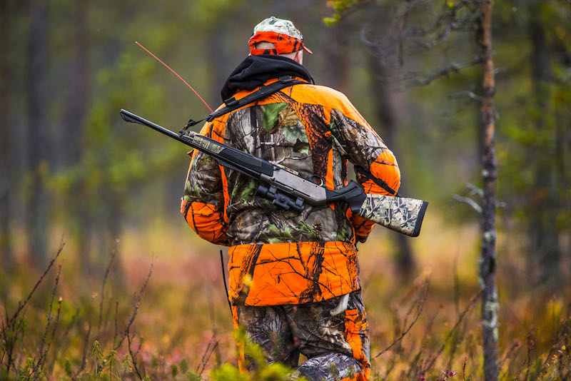 Hunter in the fall hunting season | wilderness survival guns